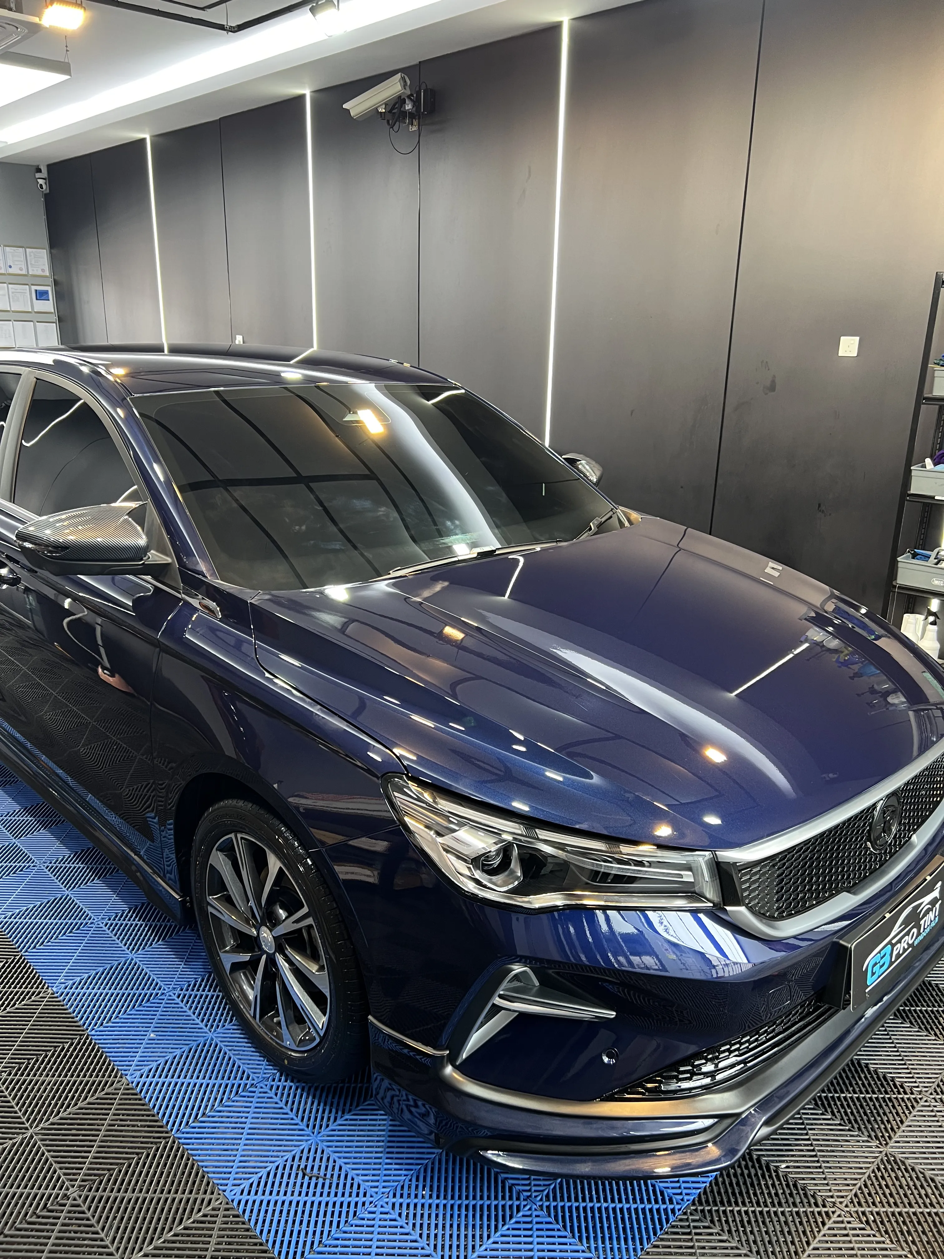 G3 showroom photo of a blue sedan with tinted windows