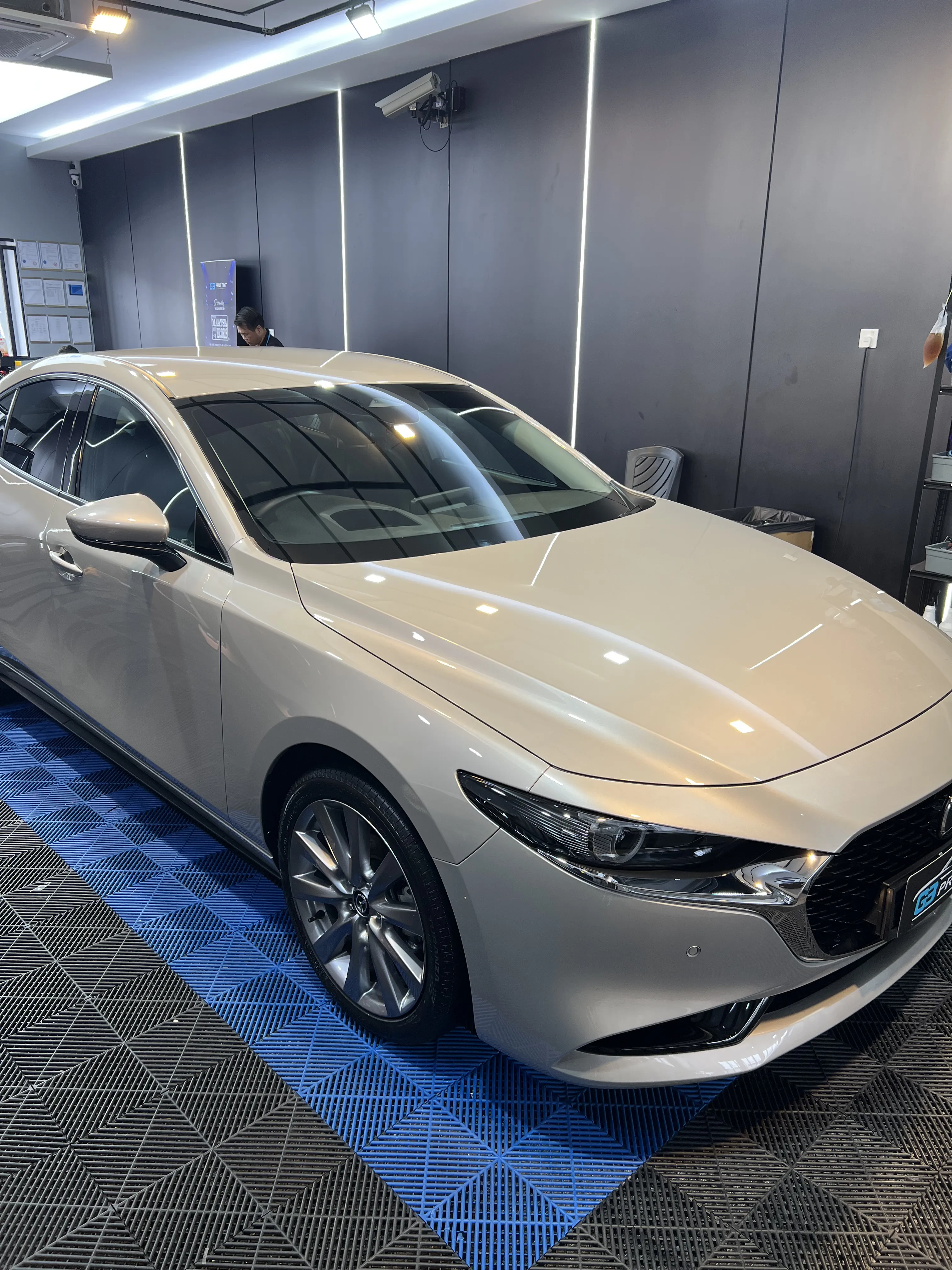 G3 showroom photo of a white sedan with tinted windows