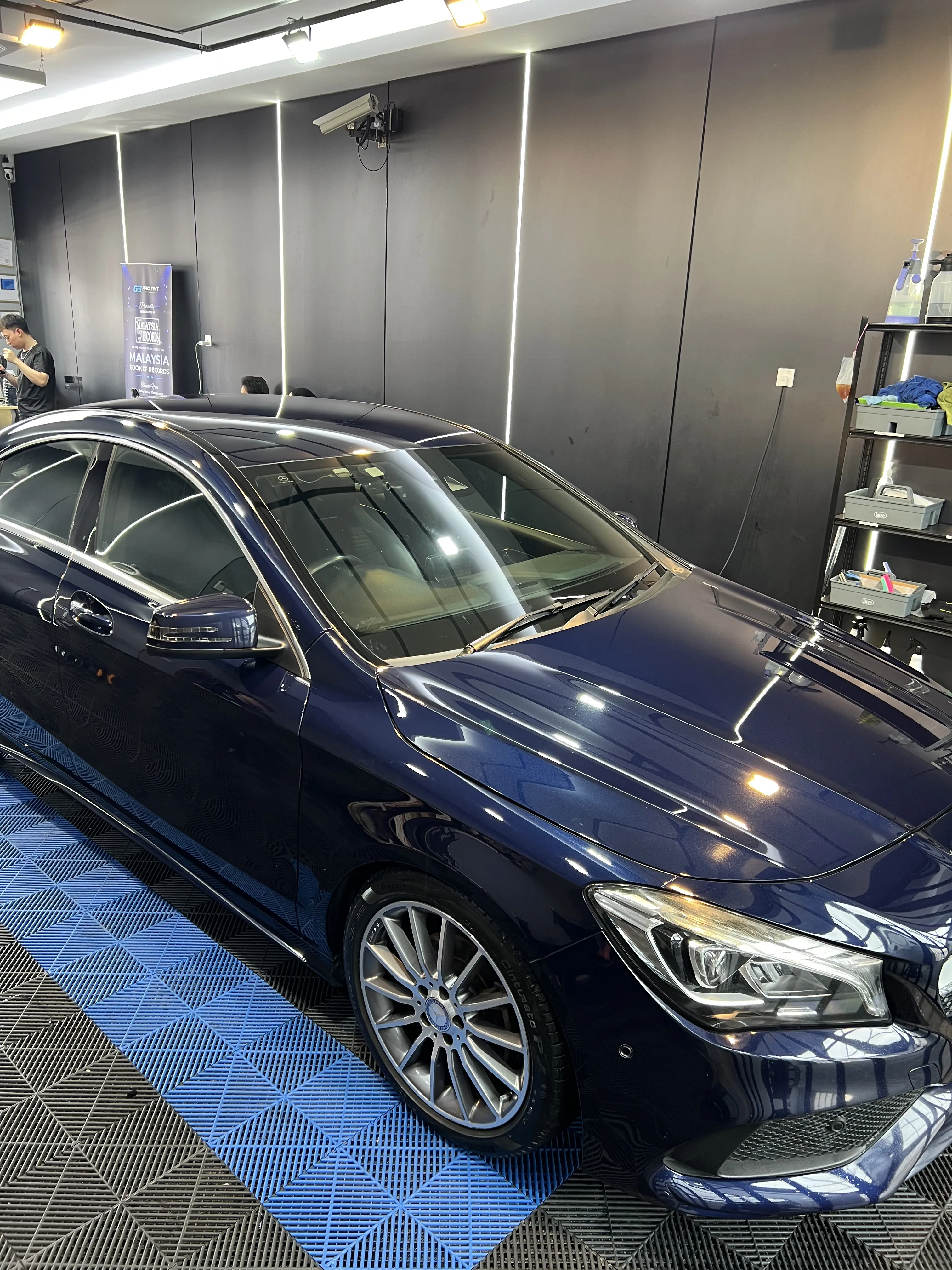 G3 showroom photo of a deep blue sedan with tinted windows