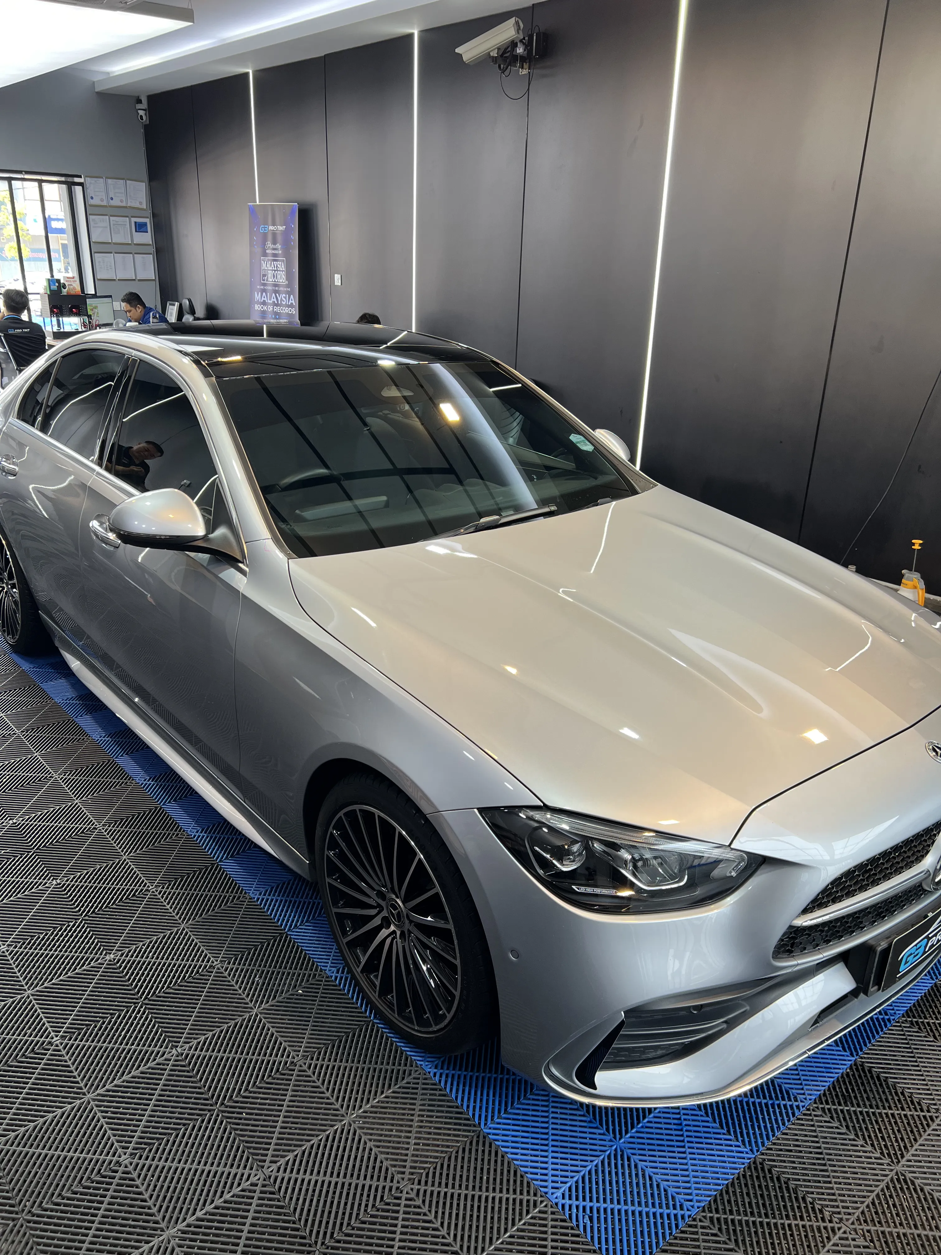 G3 showroom photo of a silver sedan with tinted windows